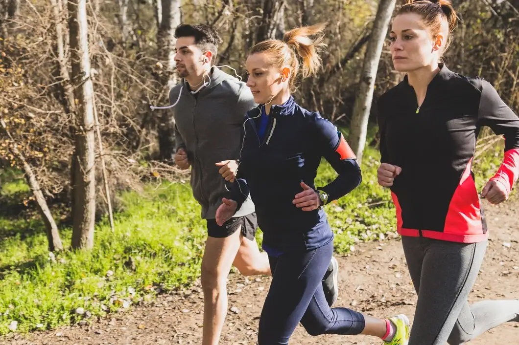Three-people-running-together-outdoors