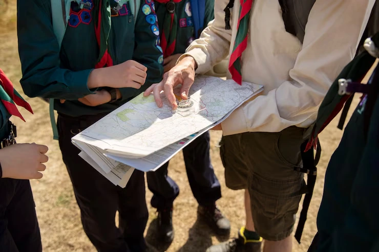 scouts-looking-at-map-with-compass-outdoor-adventure