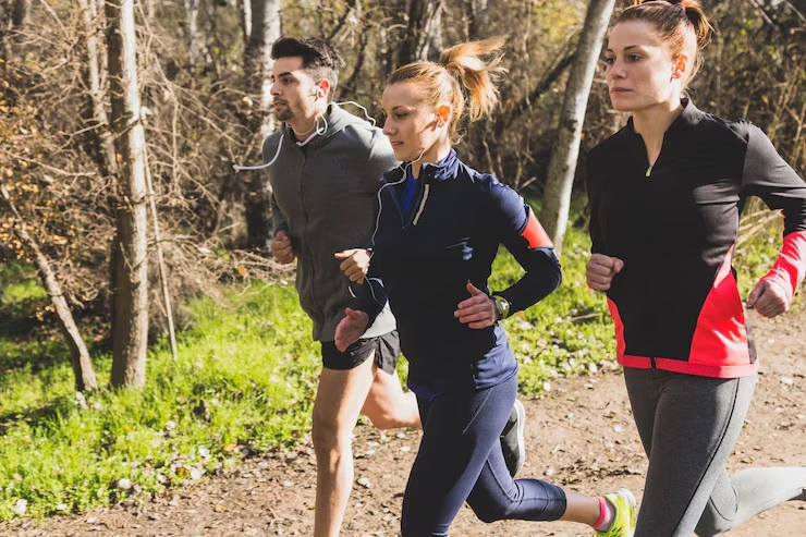 three-people-jogging-together-in-forest